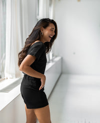 Charcoal two-way T-shirt in a bright room.