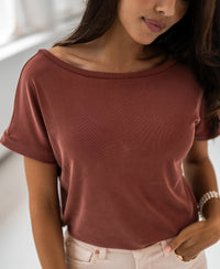 Woman in a loose two-way henna T-shirt.
