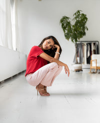 Red two-way T-shirt by PLEIN PUBLIQUE, shown on a woman in a bright room.