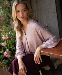 Wrap blouse with dot pattern in dusty pink and ivory, shown from the front.