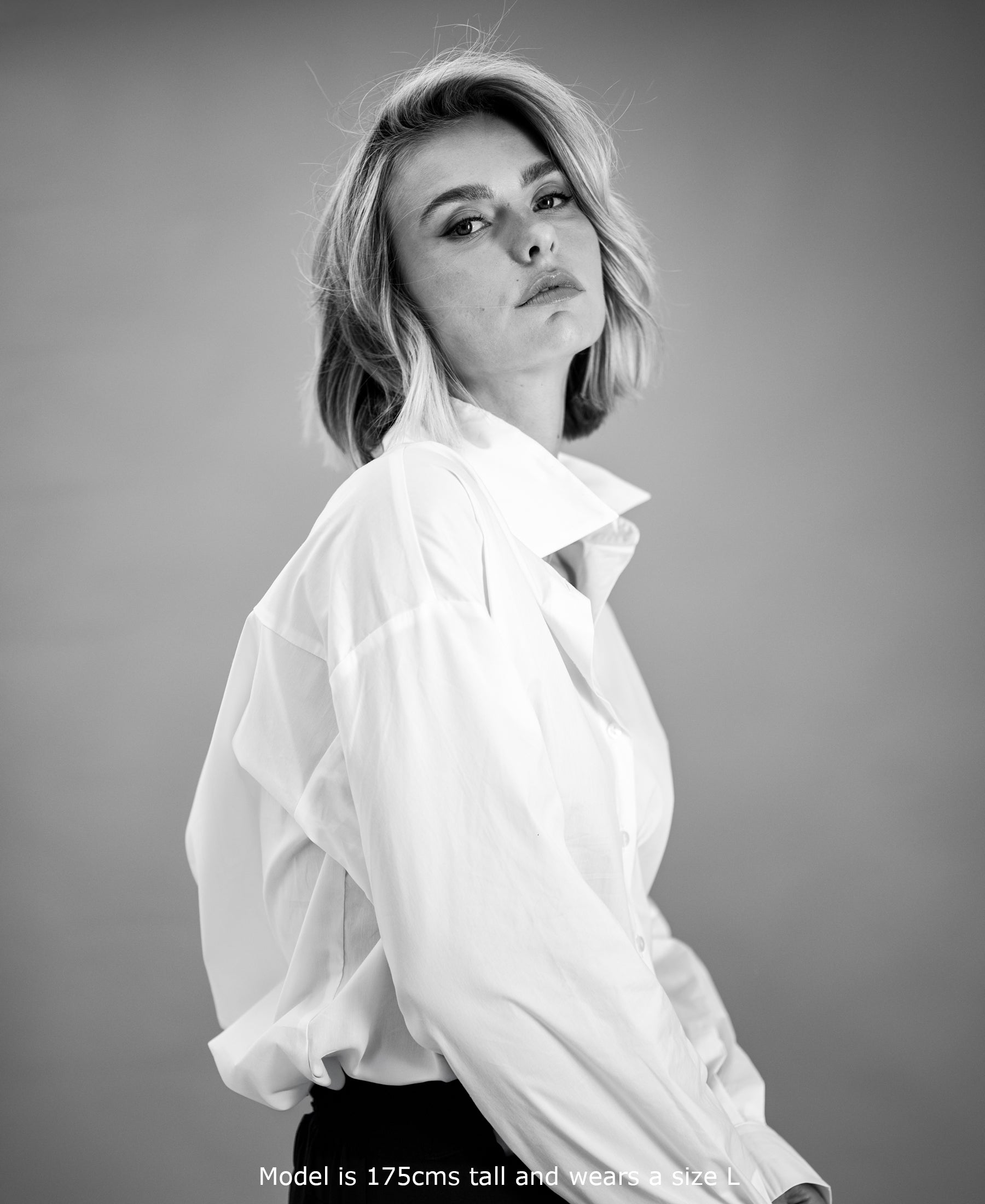 Black-and-white photo of an oversized white blouse by Plein Publique, shown from the front.
