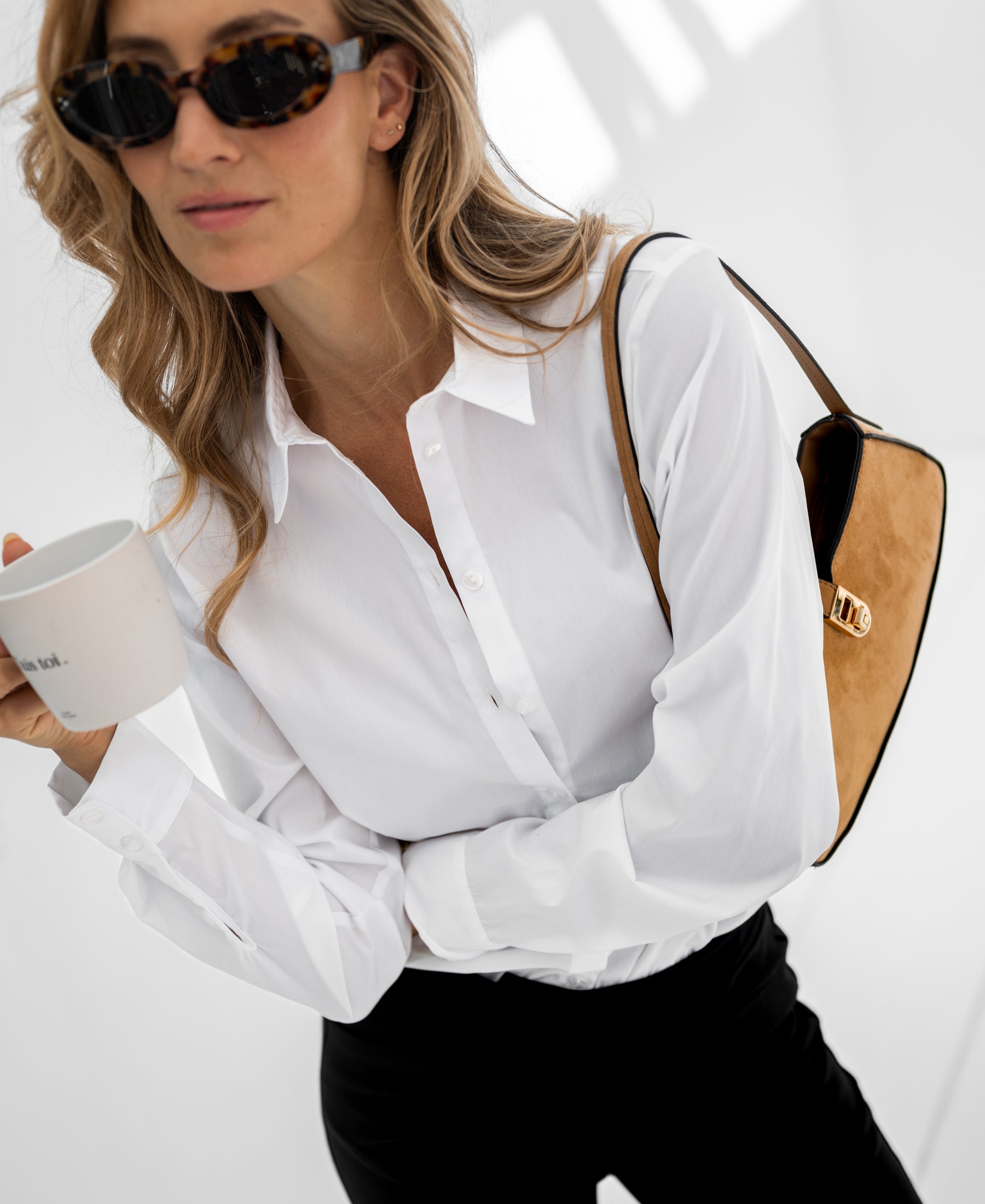 Woman wearing white LA LOIRE blouse by PLEIN PUBLIQUE.