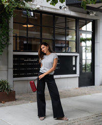 Woman wearing light gray Merino wool top.