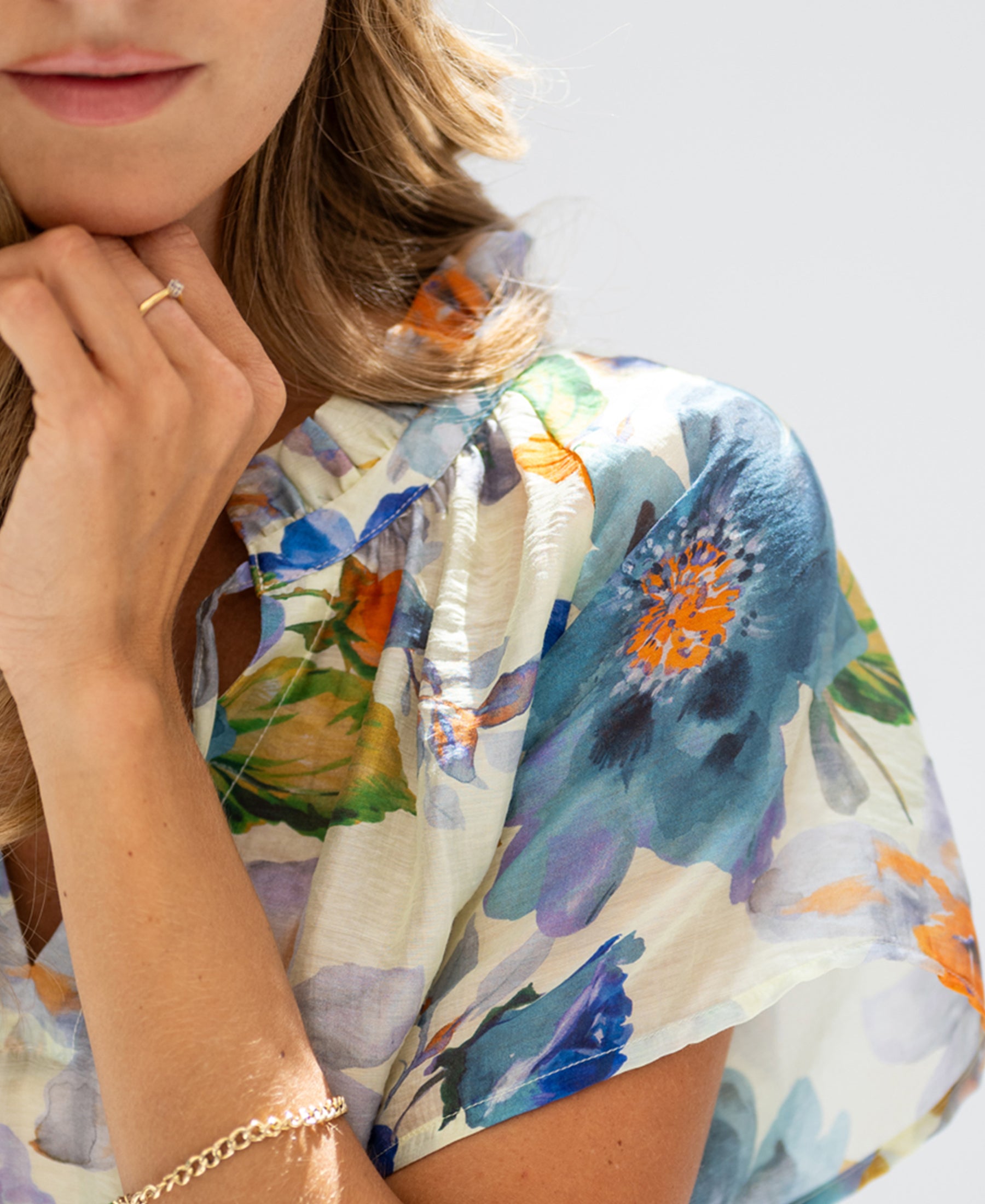 Light blue floral print blouse top with butterfly sleeves, shown in soft lighting.