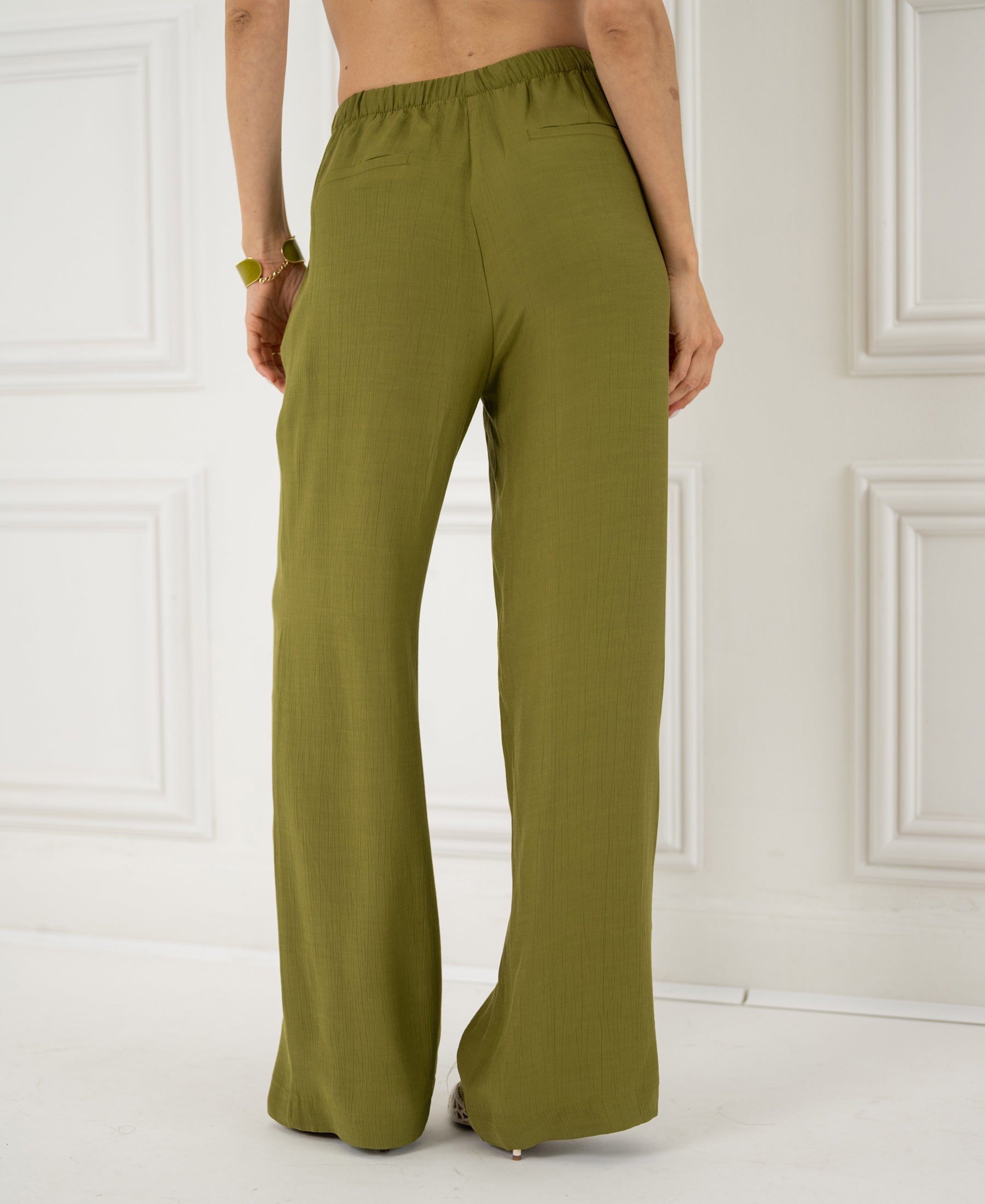 Olive wide-leg pants with elastic waist, shown from the back.