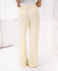 Soft yellow LA LYNETTE trousers with elastic waistband, shown from the back.