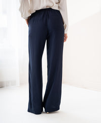Dark blue LA LYNETTE trousers with comfortable elastic waist, shown in a bright room.