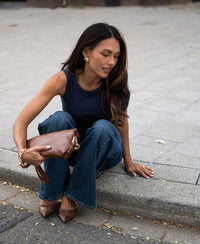 Woman wearing a dark blue PLEIN PUBLIQUE luxurious and soft boat neck top.