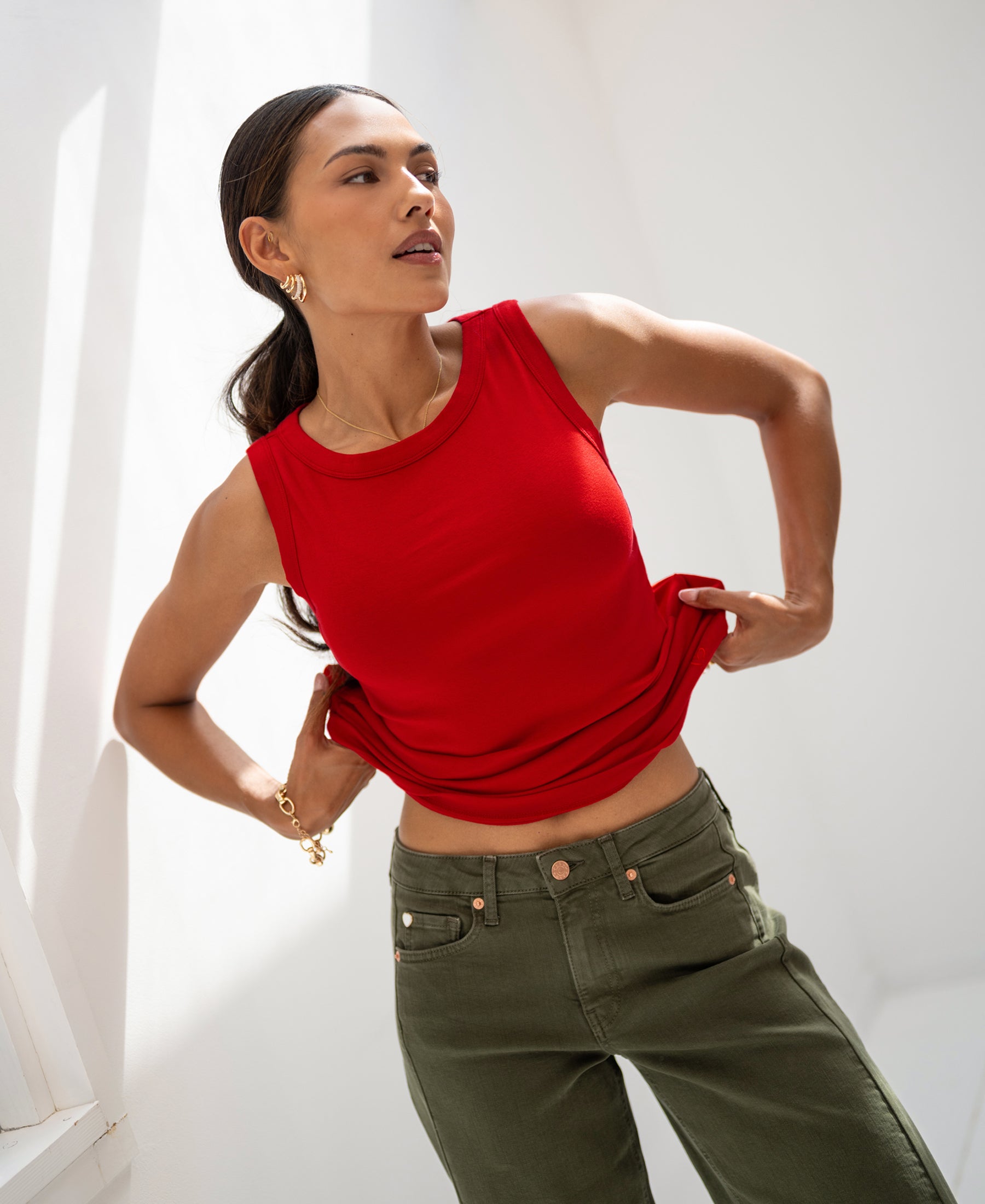 Woman wearing the Luxe & soft red boat neck top LE LYS by PLEIN PUBLIQUE, shown in bright natural light.