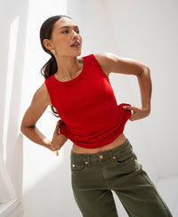 Woman wearing the Luxe & soft red boat neck top LE LYS by PLEIN PUBLIQUE, shown in bright natural light.