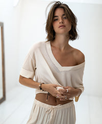 Cream silk blend LE MARDY top by PLEIN PUBLIQUE with kimono sleeves shown indoors.