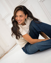 Woman wearing a luxe, soft butter-colored T-shirt by Plein Publique LA MASSY.
