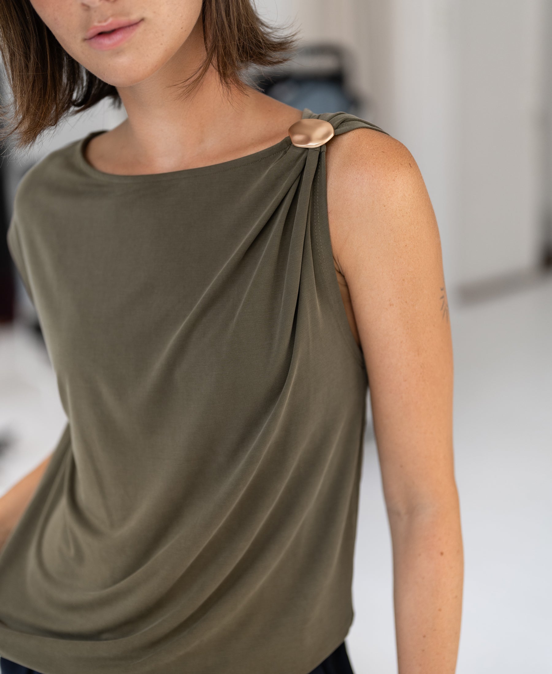 PLEIN PUBLIQUE olive green stretch jersey top with buckle detail, LA MAYA style.