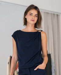 PLEIN PUBLIQUE LA MAYA dark blue top with buckle, shown indoors.