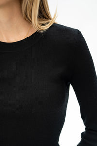 Cropped image of a black merino wool shirt in a luxe style; partial view.