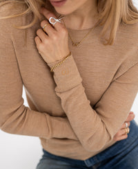 Woman wearing PLEIN PUBLIQUE's slim-fit camel Merino wool shirt, LA MEGEVE.