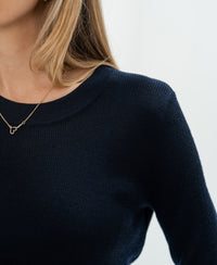 Woman wearing a PLEIN PUBLIQUE Luxe merino wool shirt in dark blue.