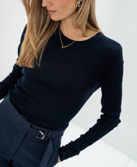 Woman wearing the PLEIN PUBLIQUE Luxe merino wool shirt in dark blue.