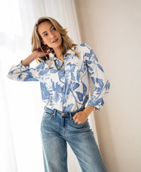 Woman wears PLEIN PUBLIQUE LA MINOU blouse with bow detail and floral print in size XL, posing indoors.