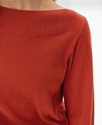 Shoulder-down view of a ribbed neckline sweater in cayenne, featuring a boat neck from PLEIN PUBLIQUE LA MUSE.