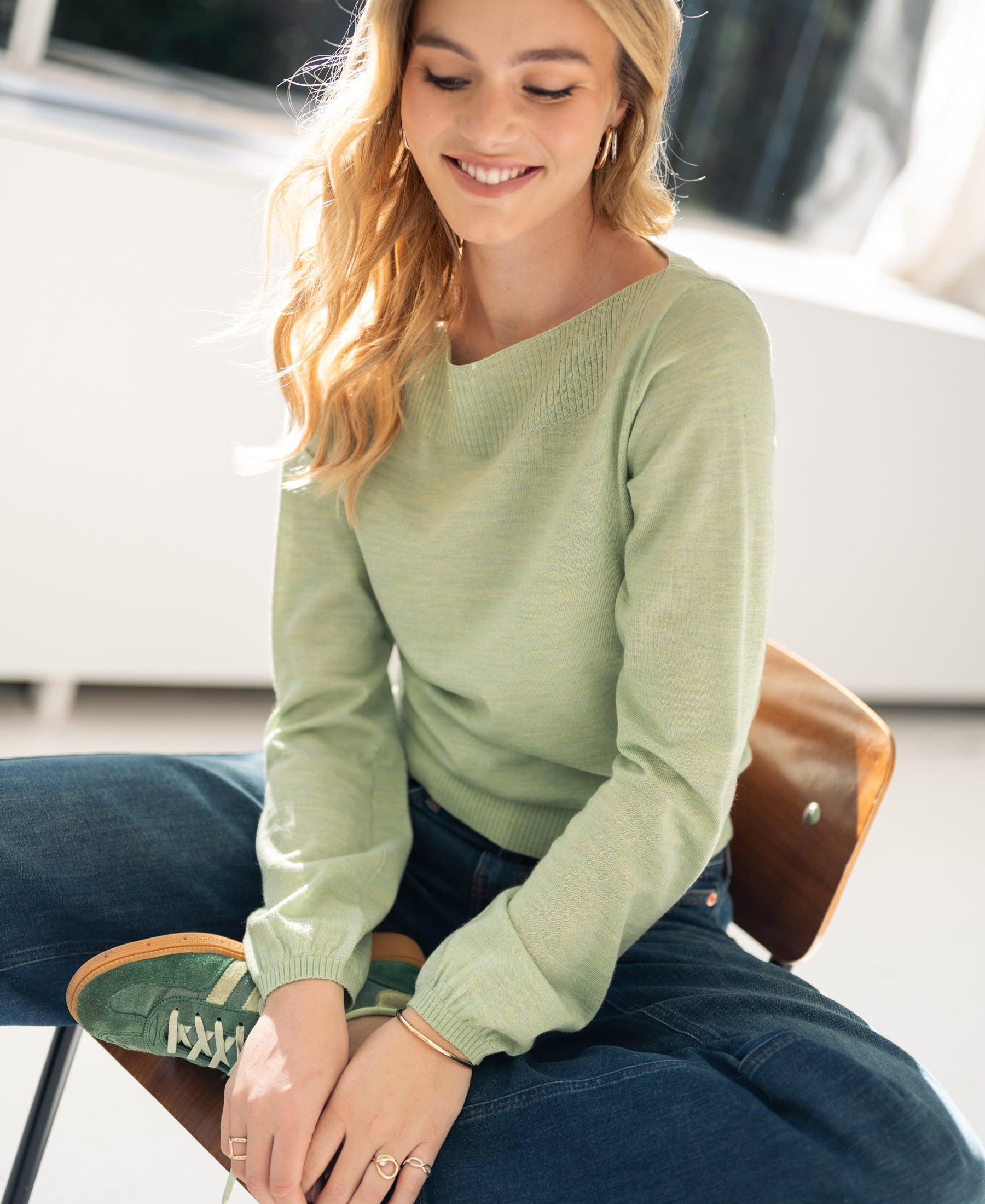 Green boatneck sweater from PLEIN PUBLIQUE LA MUSE collection shown in sunlight.