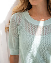 Mesh LE NANCY sweater with silk in mist green by PLEIN PUBLIQUE shown in sunlight.