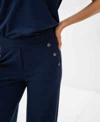 Dark blue travel pants, shown on a model against a white background.