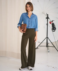 Woman wearing blue deluxe travel pants.