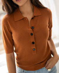Merino wool polo shirt in terra color with black buttons.