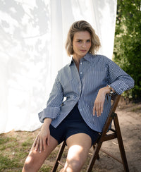 White and anthracite striped blouse, sunlight highlighting its relaxed style.
