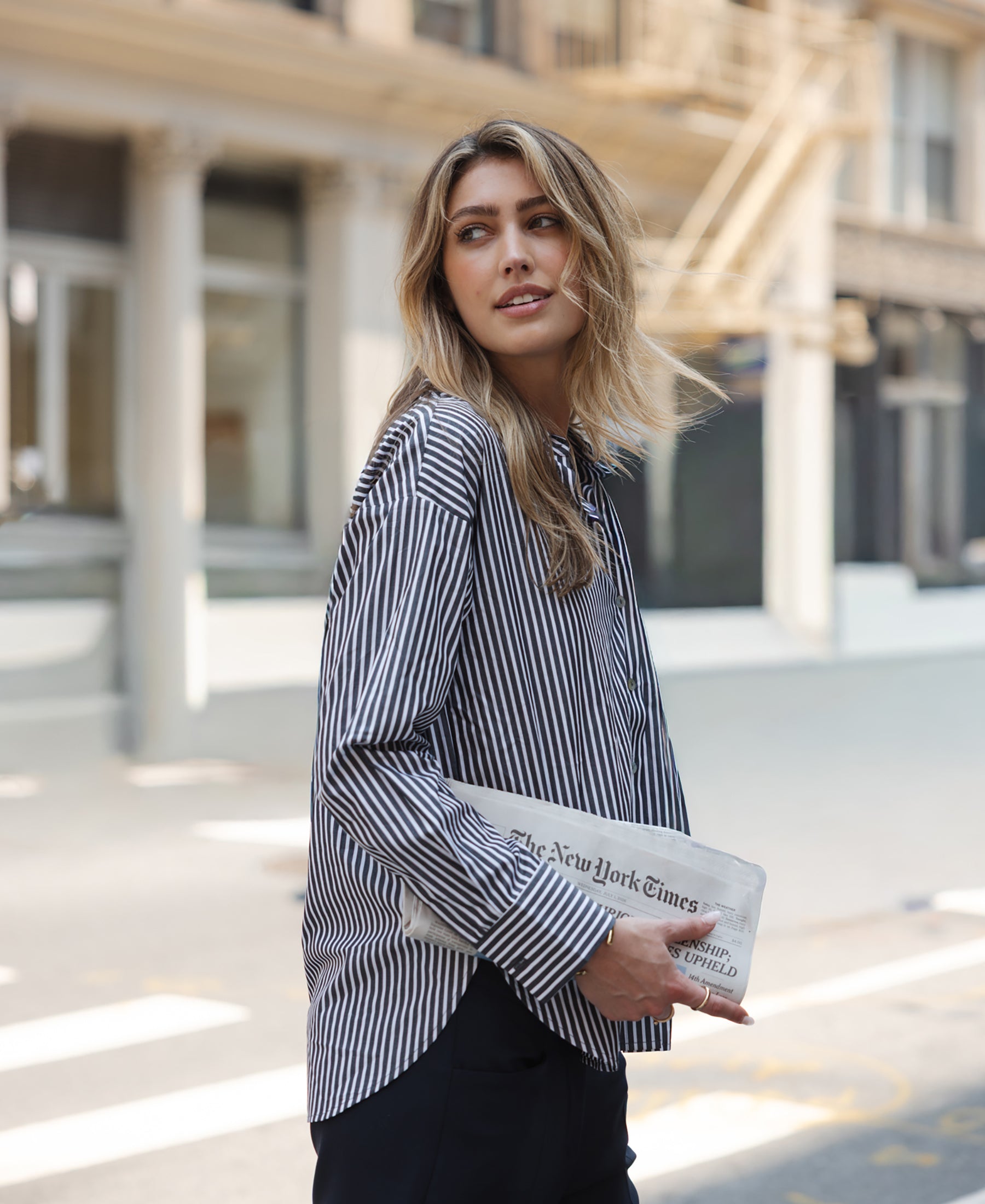 Woman wearing PLEIN PUBLIQUE LA PASCALLE blouse, white-anthracite striped.