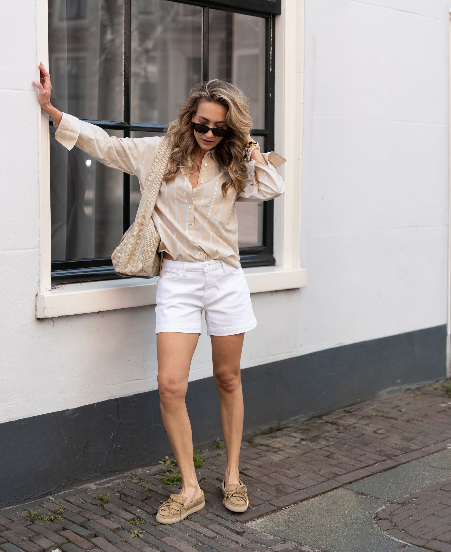 Front view of a woman wearing the LA PASCALLE blouse in sand-light blue by PLEIN PUBLIQUE.