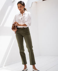 Woman in sunlight wearing a striped blouse by Plein Publique.