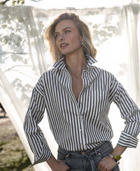 PLEIN PUBLIQUE LA PASCALLE blouse, white and olive green striped, shown outdoors in sunlight.