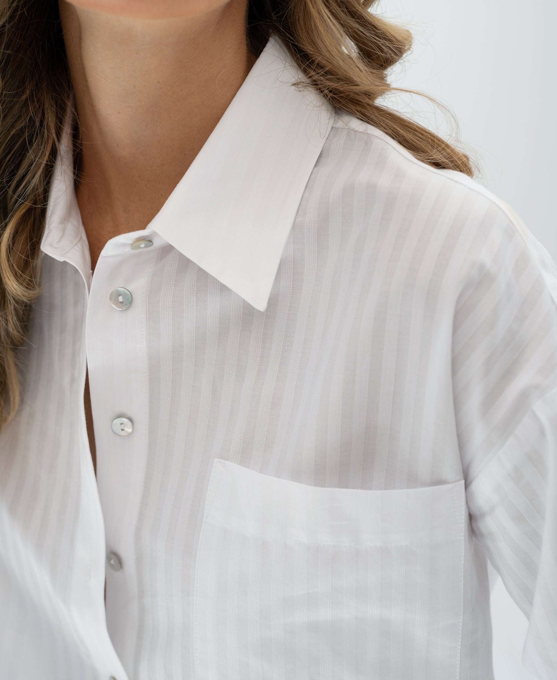 Front view of PLEIN PUBLIQUE LA PASCALLE white striped oversized blouse with chest pocket.