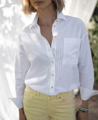 Ton-sur-ton white striped LA PASCALLE blouse photographed outside in soft sunlight.
