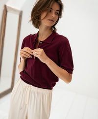 Plum and cream drawstring pants made from Merino-silk blend, shown in a bright, minimal room.