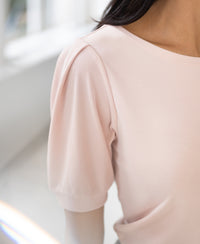 Blush ribbed T-shirt with puffed sleeves shown in a bright indoor setting.