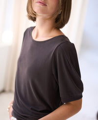 Loose-fit ribbed chocolate brown T-shirt in natural light, shown indoors.