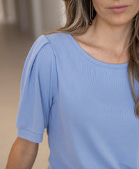 Light blue ribbed T-shirt, shown from the shoulders up.
