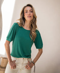 Emerald green ribbed T-shirt by PLEIN PUBLIQUE in natural indoor light.