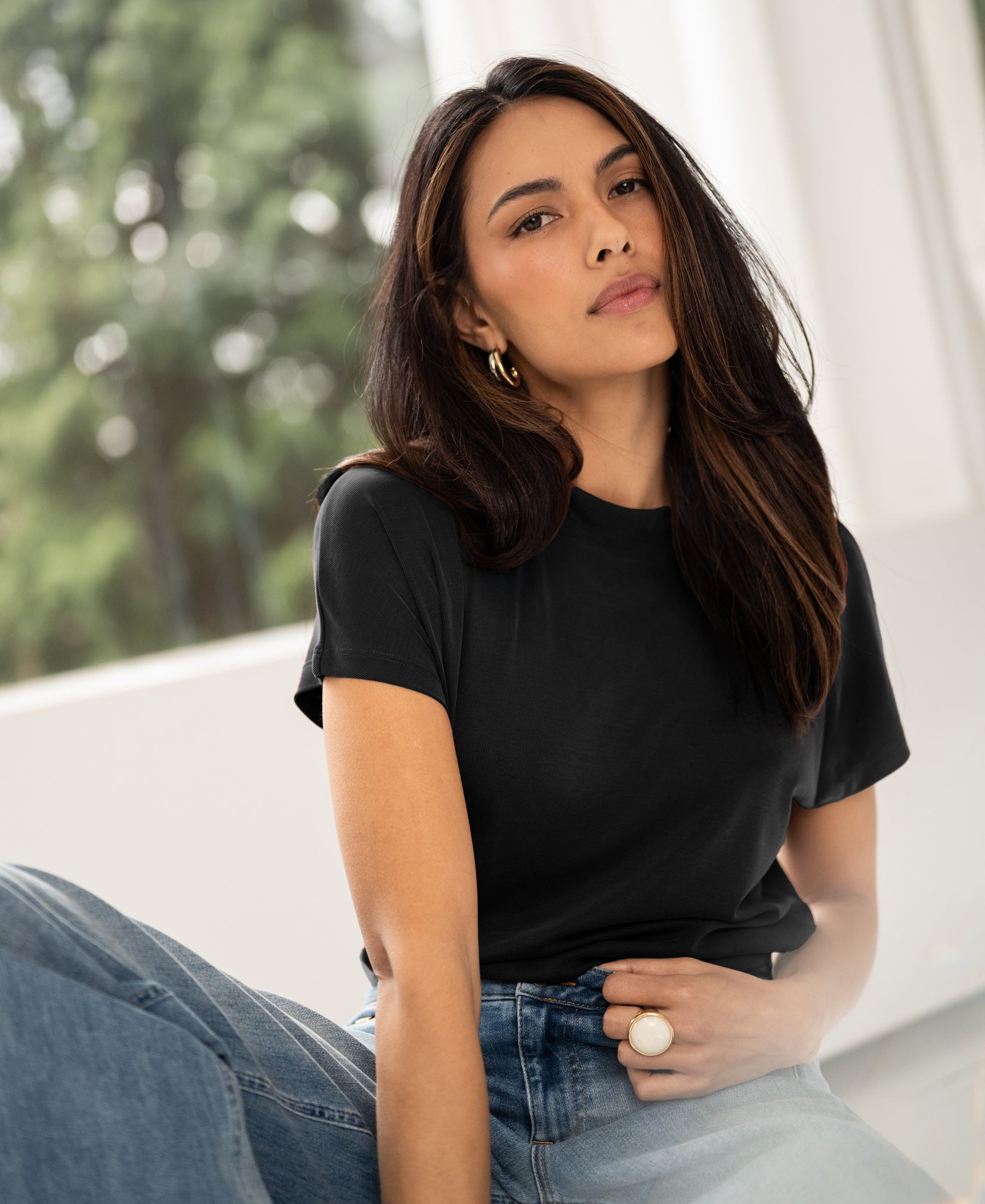 Charcoal ribbed knit top with collar, shown worn indoors.