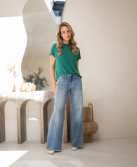 Emerald green ribbed collar top by PLEIN PUBLIQUE displayed indoors.