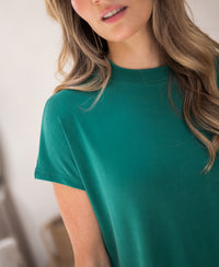 Emerald green ribbed collared top in a fitted style.