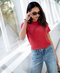 Red ribbed top in the style of LA PIERRE by PLEIN PUBLIQUE, shown indoors near large windows.