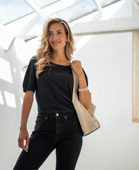 Charcoal ribbed t-shirt in a fitted style, shown worn by a woman with long blonde hair.