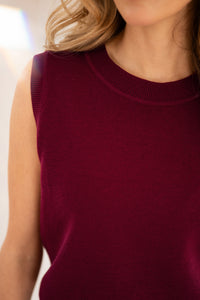 Dark red LE REVEIL cardigan by PLEIN PUBLIQUE; neck, shoulders, and part of face visible.