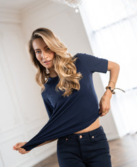 Navy stretch short-sleeve T-shirt in a relaxed fit, shown slightly lifted indoors.