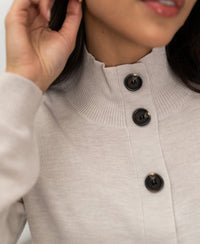 Beige merino wool vest with collar and large black buttons.