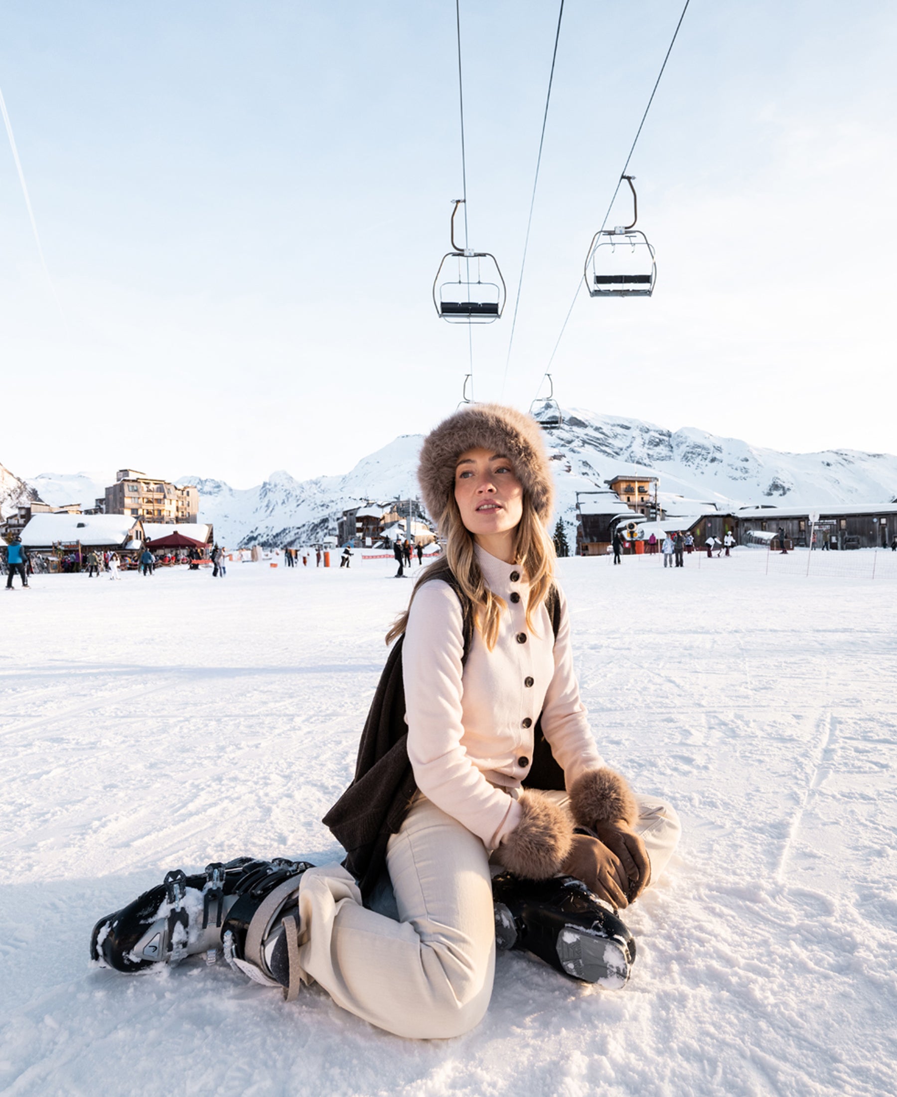 Blush pink merino wool turtleneck vest by PLEIN PUBLIQUE shown outdoors on snow.